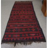 Turkish style Rug, Decorated with Geometric motifs on a red ground, 327cm x 133cm