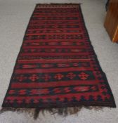 Turkish style Rug, Decorated with Geometric motifs on a red ground, 327cm x 133cm