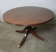 Modern Mahogany Pedestal Table, Having a circular top, Raised on quadrapartite supports with brass