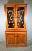 Modern Cherrywood Bookcase, Having two glazed Doors enclosing a shelved interior, Above two cupboard