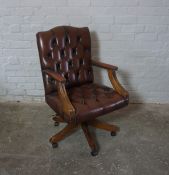 Chesterfield style Desk Armchair, The swivel chair is upholstered in faux brown leather, 95cm high