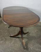 Regency style Mahogany Twin Pedestal Dining Table, With an additional leave, Raised on ring turned
