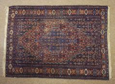 Two Persian Hand Knotted Rugs, On red and blue grounds, 150cm x 104xm, 190cm x 105cm (2)