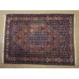 Two Persian Hand Knotted Rugs, On red and blue grounds, 150cm x 104xm, 190cm x 105cm (2)