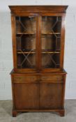 Mahogany Bookcase on Chest, Having two glazed astragal doors enclosing a shelved interior, Above two