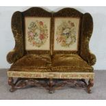 Walnut Framed Wing Back Settee, In Jacobean style, set with tapestry panels, on scroll legs and