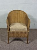 A Lloyd Loom Lusty Chair in Gold, with matching cushion