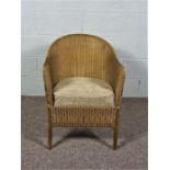 A Lloyd Loom Lusty Chair in Gold, with matching cushion