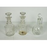 A pair of triple ring neck decanters and stoppers, 19th century, with paneled bodies, and a