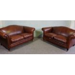 Two Tan Leather Three Seater Sofas with Castor Legs and scroll arms, 170 x 105 x 90 cm