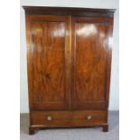 George III Style Mahogany Wardrobe, Having two doors above a large drawer, 207cm high, 143cm wide,