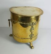 Brass Coal Depot, Early 20th century, Of cylindrical form with hinged cover, stylised feet, 31cm