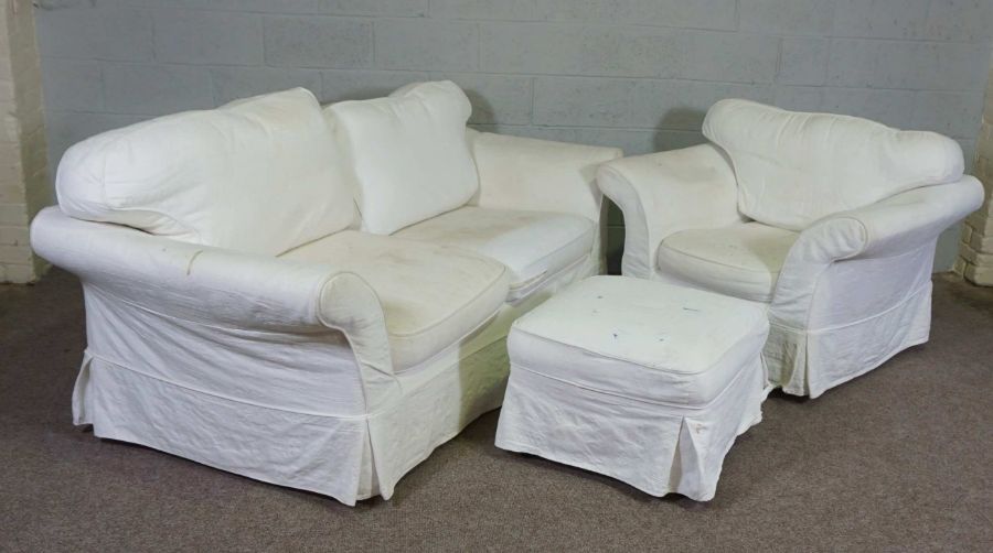 A modern three seater sofa, armchair and ottoman, currently with white linen covers (3)