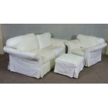 A modern three seater sofa, armchair and ottoman, currently with white linen covers (3)