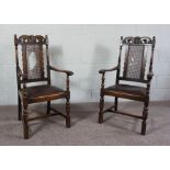 A pair of oak framed Carolean style armchairs, early 20th Century, with fretwork carved crest rails,
