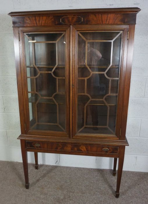A George III style mahogany china cabinet on stand, 20th century reproduction, with two astragal