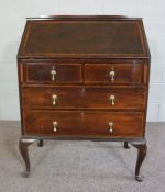 A George III style mahogany veneered bureau, early 20th century, with a writing slope opening to