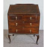 A George III style mahogany veneered bureau, early 20th century, with a writing slope opening to