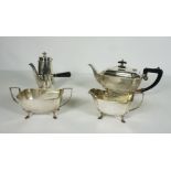 A silver plate four piece tea and coffee service, comprising a tea pot, coffee pot with wooden