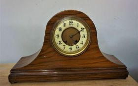 Walnut Cased Mantle Clock on domed form with ball feet