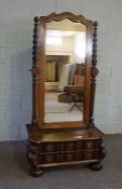 A Dutch Colonial style stinkwood cheval mirror, the shaped plate held within part twist column