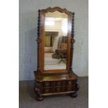 A Dutch Colonial style stinkwood cheval mirror, the shaped plate held within part twist column