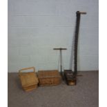 A fishing basket and another basket, with a small portable till, a two ended crosscut saw, a hand