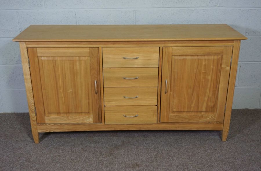 A modern ash low dresser, with four drawers flanked by cabinets, 81cm high, 151cm wide