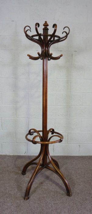 A bentwood coat stand, in the manner of Thonet, with eight scrolled hat hooks, set on a cluster