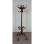 A bentwood coat stand, in the manner of Thonet, with eight scrolled hat hooks, set on a cluster