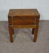 A small Victorian writing box, with brass straps, set on a later stand