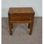 A small Victorian writing box, with brass straps, set on a later stand