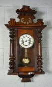 An American walnut cased wall clock, circa 1900, with a circular enamelled dial, roman numerals