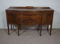 A George III style mahogany sideboard, reproduction, 20th century, with two drawers, flanked by