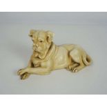 A German porcelain figure of a mastiff or boar hound, naturalistically modelled lying with paws