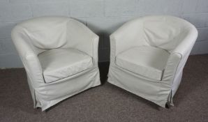 A pair of cream linen covered tub chairs with a removable cushion and loose covers