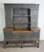 A 19th century Lancashire style dresser, later painted, the moulded cornice over shelves, flanked by
