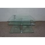 A modern glass foldout coffee table, with square top, 42cm high, 79cm wide