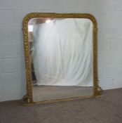 A Victorian composition gilt framed overmantel mirror, with a rounded rectangular plate and