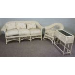 A white painted wicker three seat sofa, 180cm wide, together matching rocker armchair and a wicker