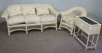 A white painted wicker three seat sofa, 180cm wide, together matching rocker armchair and a wicker