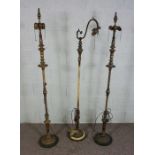 Three assorted gilt and painted metal standard lamps, tallest 158cm high (3)