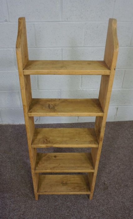 A modern stained pine open bookshelf, with five tiers