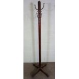 An Edwardian coat stand, with brass fittings, on square section column and x framed sledge foot