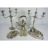 An assortment of silver plate, including a pair of Georgian style three light candelabra, a hot