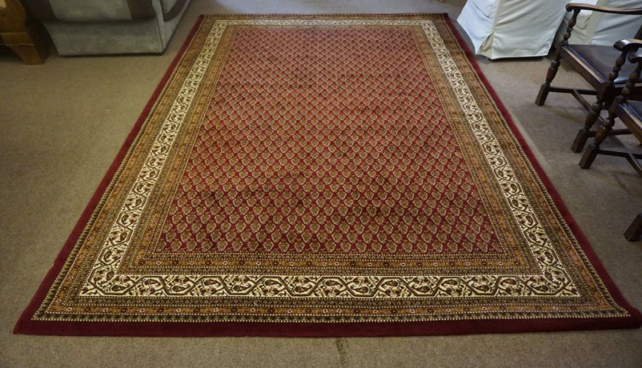 A large Bokhara style wool rug, late 20th century, made in Belgium, with multiple rows of flower