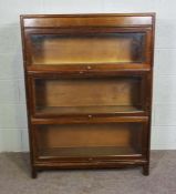 A Globe Wernicke style three section bookcase, each shelf with a glazed hinged door, 20th century,