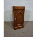 A Victorian mahogany bedside cabinet, circa 1870, with arched panelled door, 76cm high, 36cm wide