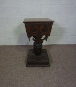 A Jacobean style oak teapoy, 19th century, with a hinged rectangular top with beaded rim, over an