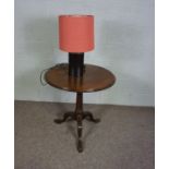 A George II style mahogany wine table, with hinged circular top and birdcage and pillar support on